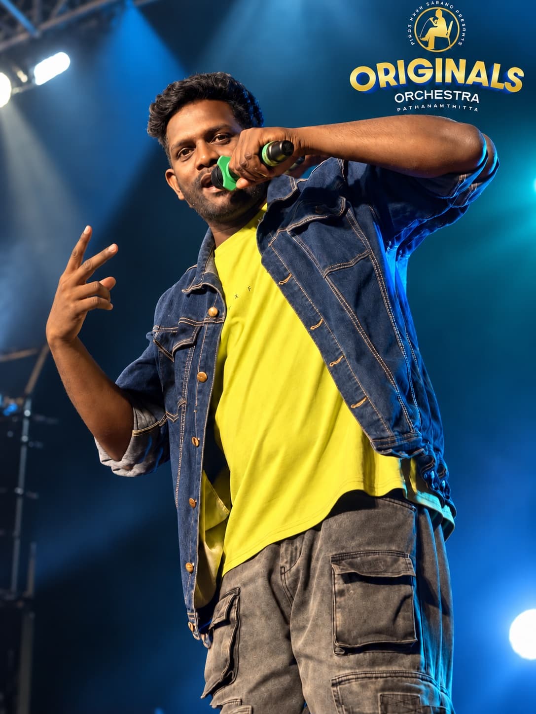 Originals Orchestra vocalist performing in a denim jacket
