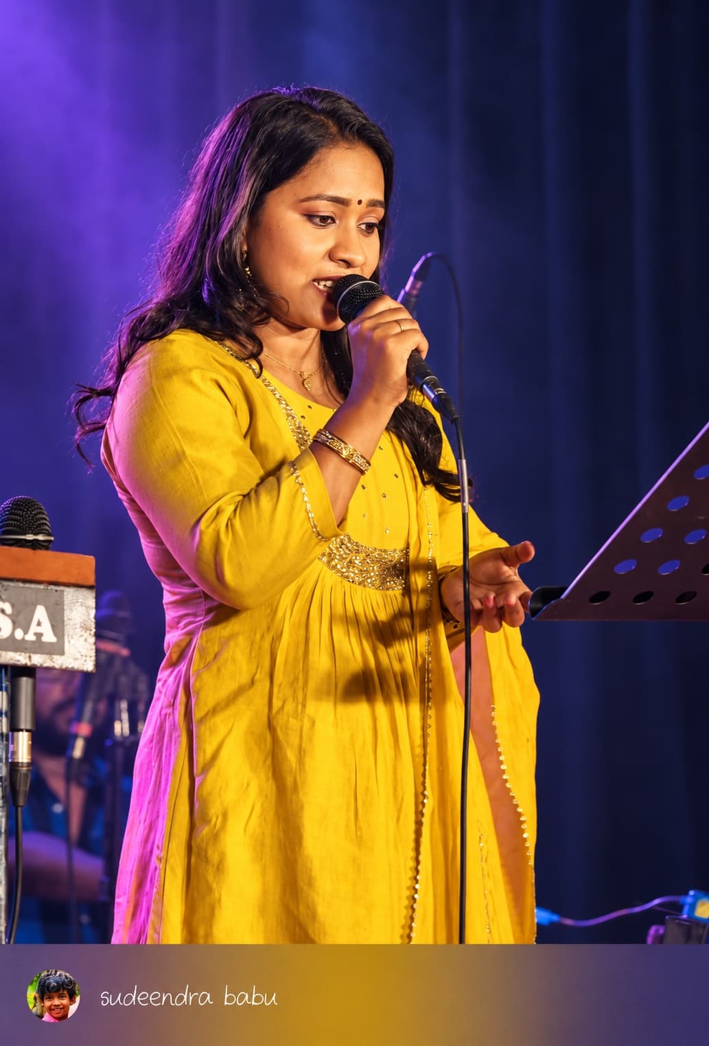 Originals Orchestra vocalist performing in a yellow dress
